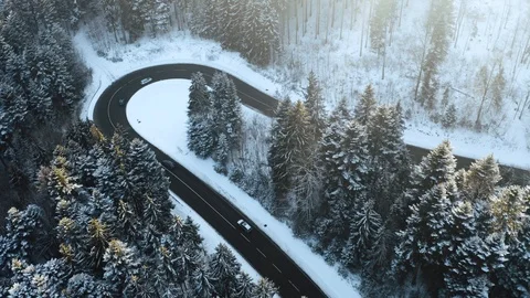 Overhead aerial top view over car travelling on hairpin bend turn road in Stock Footage 102834524