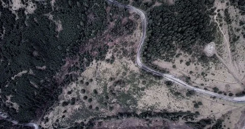 Overhead aerial top view over car travelling on road in countryside autumn Stock Footage 128916332