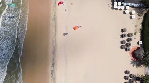 Overhead Aerial View of Beach Umbrellas and Kitesurfing Coast at Mui Ne in Phan Vidéo 344998511