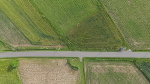 Overhead aerial view of a single car traveling on a narrow country road Stock Footage 324520932