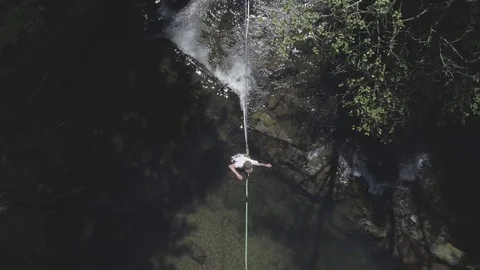 Overhead Aerial View of Slackliner by Flowing Creek (flat cine profile) Stock-Footage 81844892