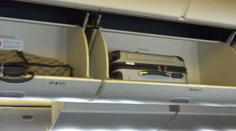 Overhead baggage in airplane Stock Footage 12466062