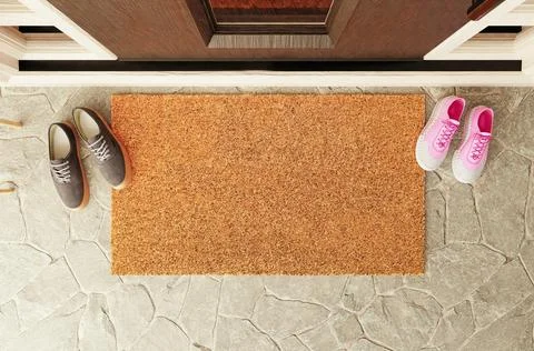 Overhead of blank doormat with man and woman shoes on the porch at the fron.. Ilustração Stock