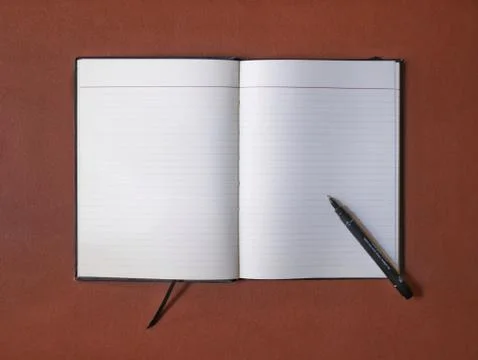 Overhead: blank open notebook and a black pen on a leather desk Stock Photos