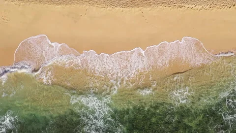 Overhead blue green waves breaking on golden sand beach 03  2.7k 60fps Stock Footage 155779951
