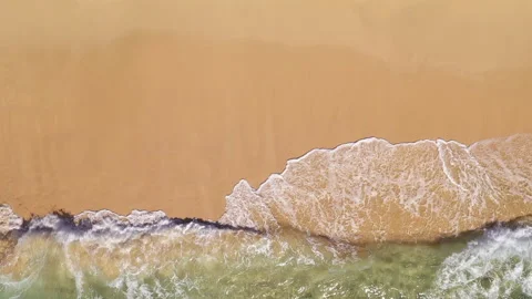 Overhead blue green waves breaking on golden sand beach 2.7k 60fps Stock Footage 155780404