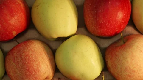 Overhead camera zoom into fresh apples inside rustic basket Stock Footage 339299496