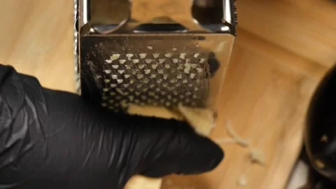 Overhead Cheese Grating  Culinary Geometry and Texture Stock Footage 311543912