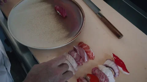 Overhead chef plating raw fish and seafood nigiris Stock Footage 317456876