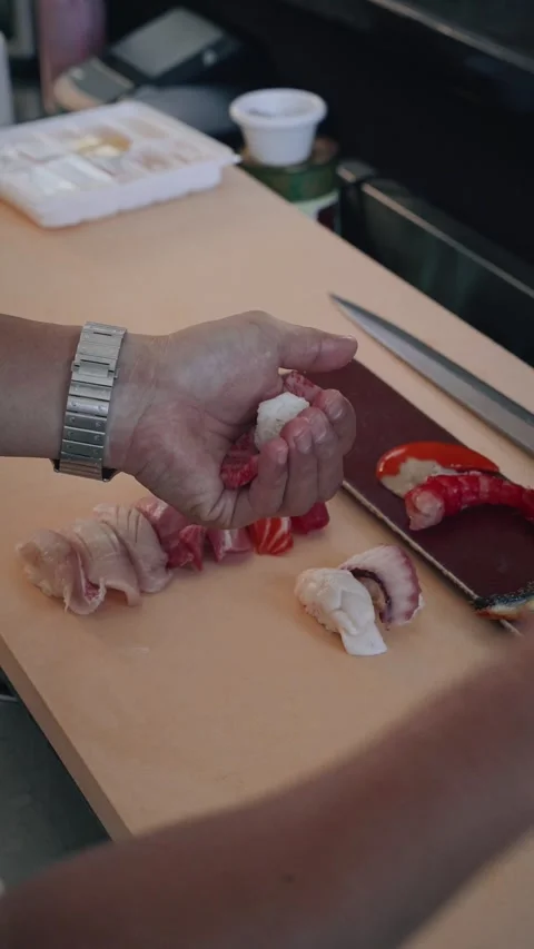 Overhead chef preparing wagyu beef nigiri assortment Stock Footage 317456866
