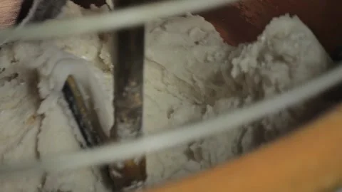 Overhead close-up of copper mixer stirring thick creamy chocolate mixture at Stockbeeldmateriaal 327789593