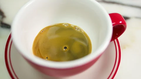 Overhead Close Up of Fresh Espresso in Red Cup on Marble Table Stock Footage 337652721