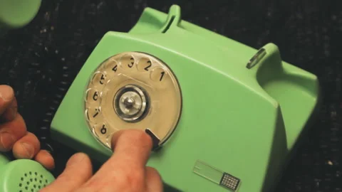 Overhead close-up hand dialing number on a vintage mint green rotary telephone Vídeo Stock 337328226