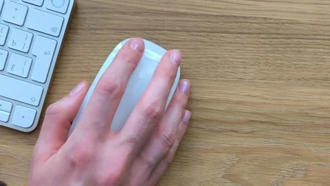 Overhead close-up of a hand scrolling a computer mouse. Fingers clicking be.. Stock Footage 340283910