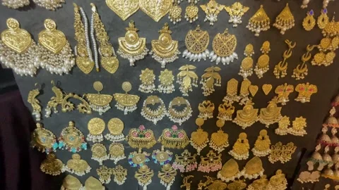 An overhead close-up shot of an elegant collection of traditional gold-plated  Stock Footage 347154505