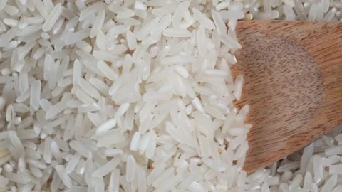 Overhead close up shot of scooping the spinning rice with wooden spoon 库存影片 277782666