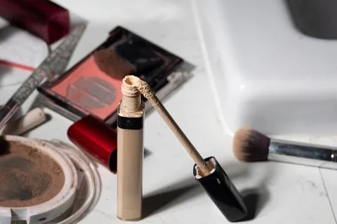 Overhead close-up showcases partially emptied cosmetics, worn applicators, an Stock Photos