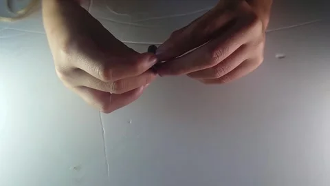 Overhead Close Up View of Hands Threading Cord Through Ancient Clay Spinning Stock Footage 345042022