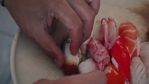 Overhead closeup chef hands plating nigiri sushi assortment 4K Stock Footage 317504687