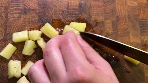 Overhead closeup of a hand cutting pickled cucumber into small pieces with .. Stock Footage 346208707