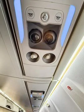 Overhead control panel in airplane cabin with lights and air vents. Passenger Foto stock