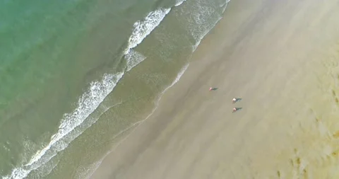 Overhead, Couple Biking on Empty Beach Landscape, Aerial Drone Video stock 141991702
