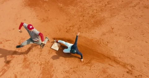 OVERHEAD CRANE Base runner attempts to touch a base during a baseball game Stock Footage
