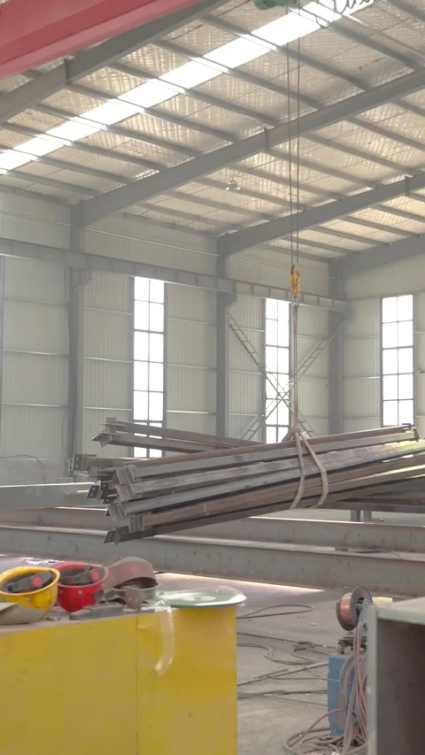 Overhead Crane Transporting Structural Steel Beams Inside Manufacturing Plant Stock Footage 339384631