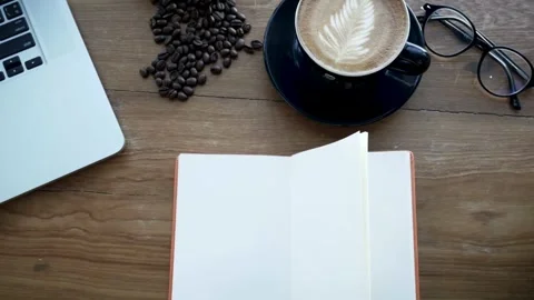 Overhead Creative Space: Coffee, Laptop, and Blank Notebook on Wood Stock Footage 319511446