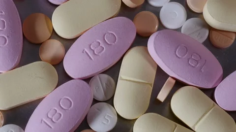 Overhead CU of of pills rotating Stock Footage 55365808