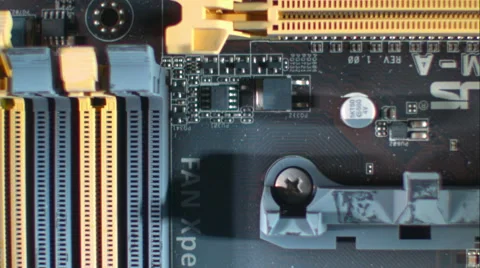 Overhead diagonal sweep across circuit board. Slow motion. ECU. Stock Footage 64881773