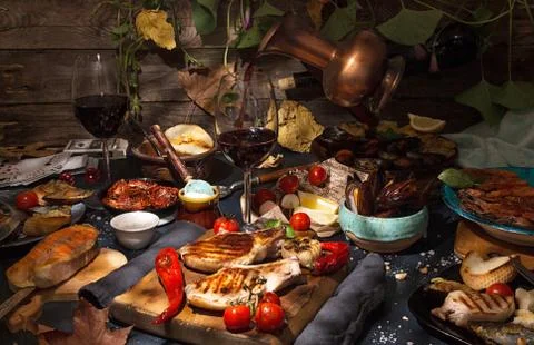 Overhead of dinner table. Assorted grilled barbecue meat and seafood with veg Stock Photos