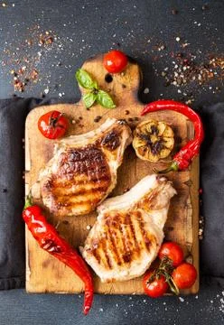 Overhead of dinner table. Delicious grilled barbecue pork meat on old wooden  Stock Photos