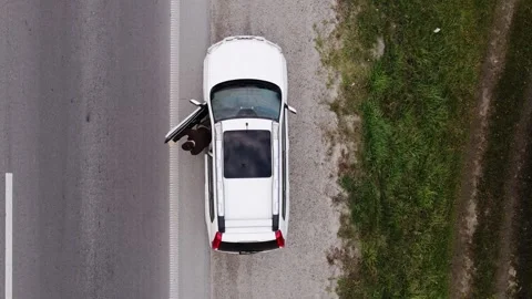 Overhead directly above view of a man going out of a car parked at road side  Vídeos de archivo 148227075