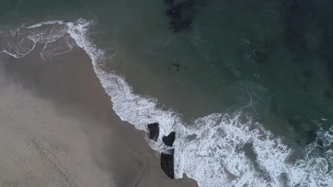 Overhead drone clip of the crushing waves on the beach. Aerial footage top vi Stock Footage 201198083