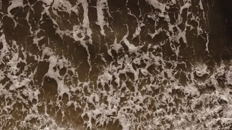 Overhead drone close-up of a breaking wave with intricate sea foam patterns Stock Footage 340929205