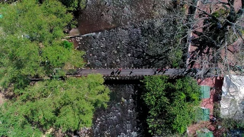 Overhead drone flight over a river  bridge in Central America Stock Footage 101309809