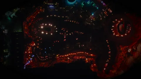 Overhead Drone Flight in Theme Park at Night with Fireworks Neon Lights Stock Footage 166713302