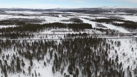 Overhead drone footage capturing a serene wintry scene of roads and railways Stock Footage 330376734
