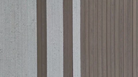 Overhead drone shot of alternating pale and dark furrows stretching across Stock Footage 310180307