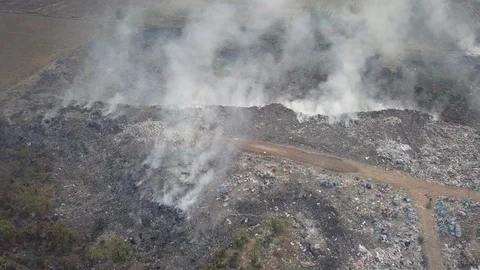 Overhead drone shot burning garbage at dump site Stock Footage 126553004