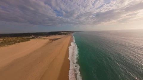 Overhead drone shot captures calm beach meeting ocean at sunset Stock Footage 340225822
