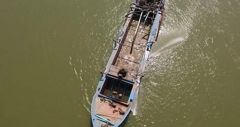 Overhead drone shot of a dredging boat on river pumping riverbed sand Stock Footage 105349373