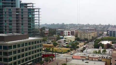 Overhead drone shot looking down at a trolley and bus moving through downtown Видео 332687152