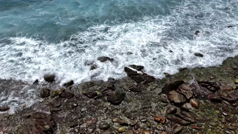 Overhead Drone Shot of Ocean Water Flowing Over Smooth Rocks on the Cabo del Stock Footage 340154207