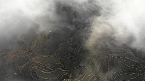 Overhead drone shot powerful clouds enveloping over rice terrace landscape China Stock Footage 109540803