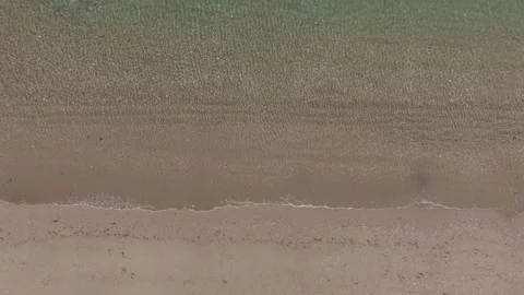 Overhead Drone Shot of pristine clear beach with waves and palm trees Stock Footage 279752694