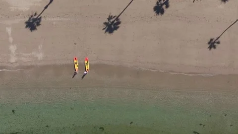 Overhead Drone Shot of pristine clear beach with waves paddle boards sup Stock Footage 279752698