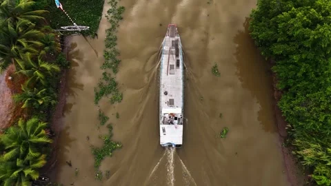 Overhead drone shot tracking cargo boat leaving v-shaped water wake Stock-Footage 342924421