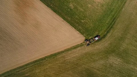 Overhead drone shot of tractor in a field. Smooth spin. Stock Footage 90944896